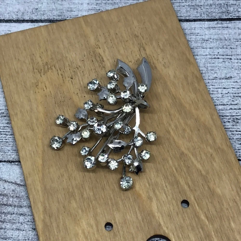 Vintage rhinestone flower branch statement glam brooch.